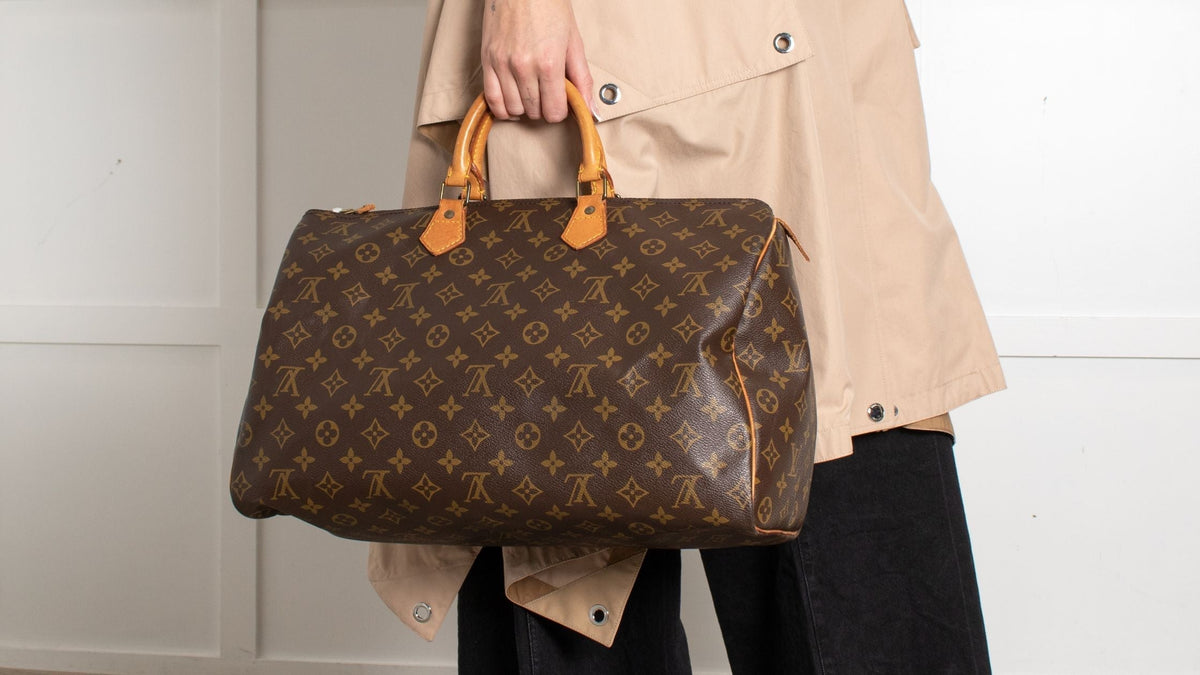 Authentic Louis Vuitton Speedy 25 with upside-down monogram on back panel