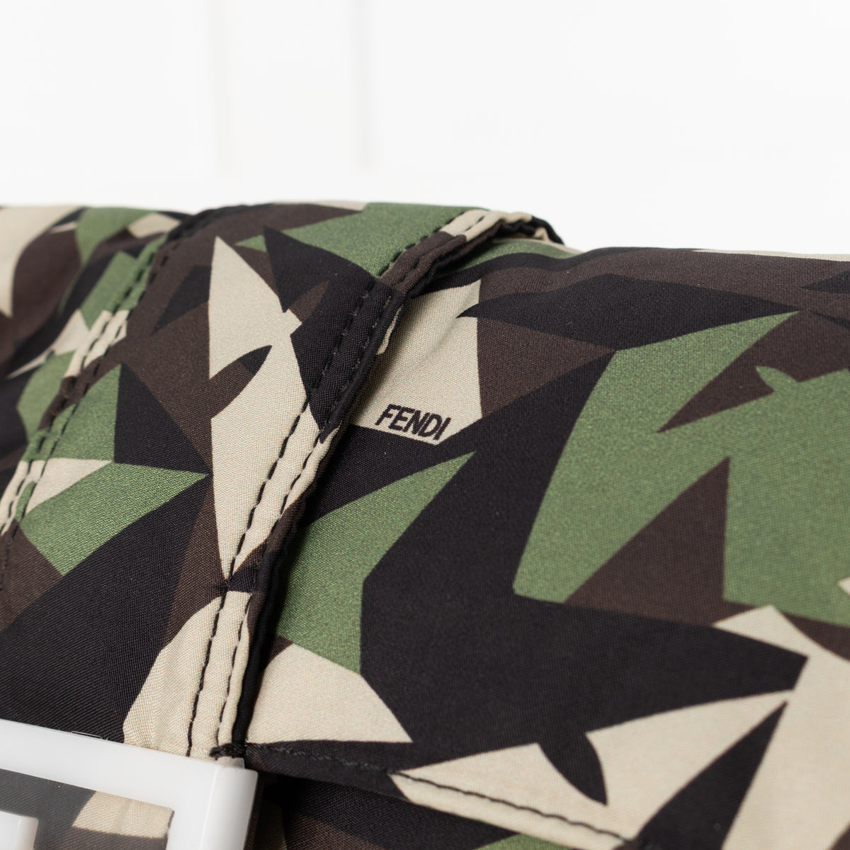 Close up of Fendi text logo on the Fendi Green Nylon Camouflage Convertible Baguette Satchel bag.