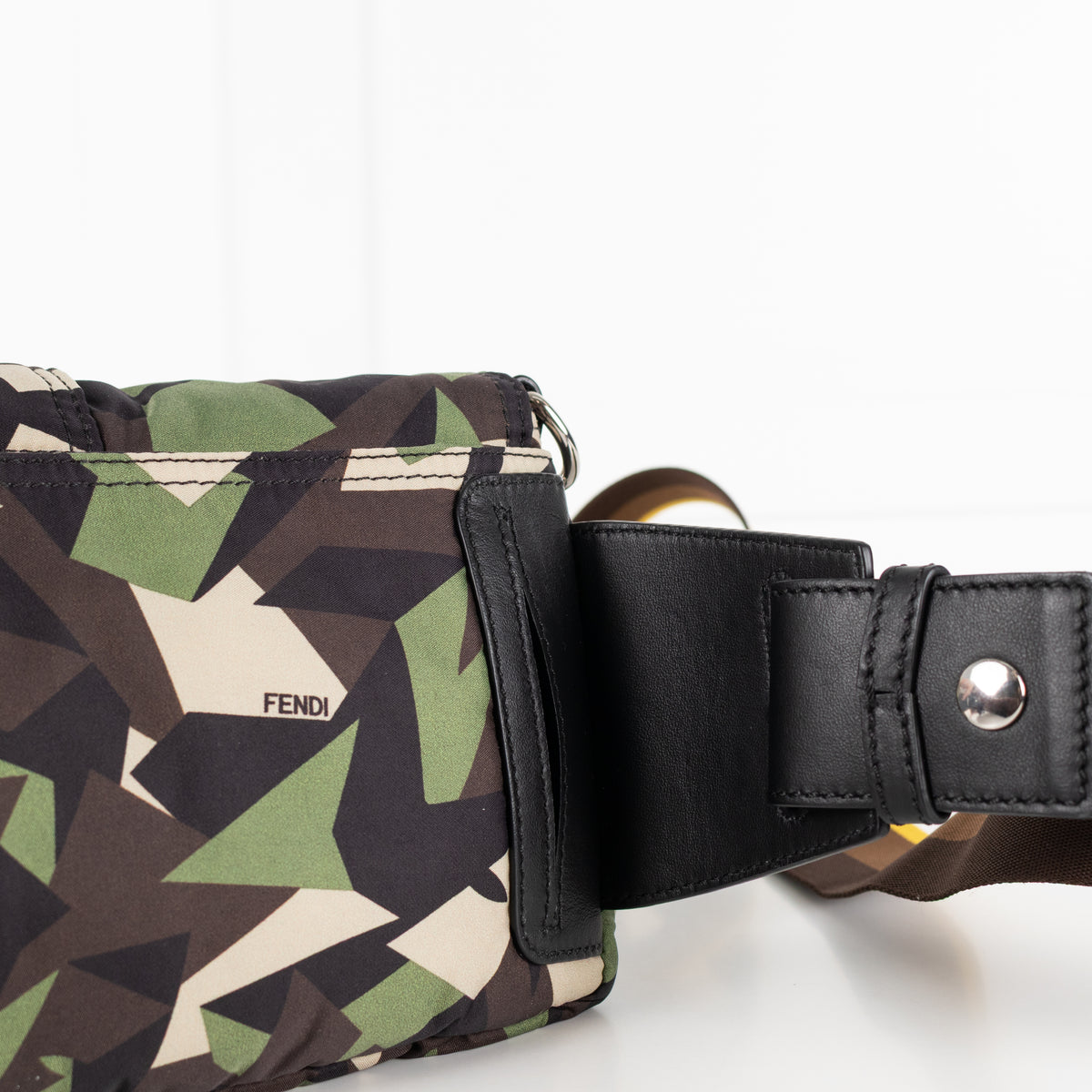 Close up of black leather strap detail on the Fendi Green Nylon Camouflage Convertible Baguette Satchel bag.