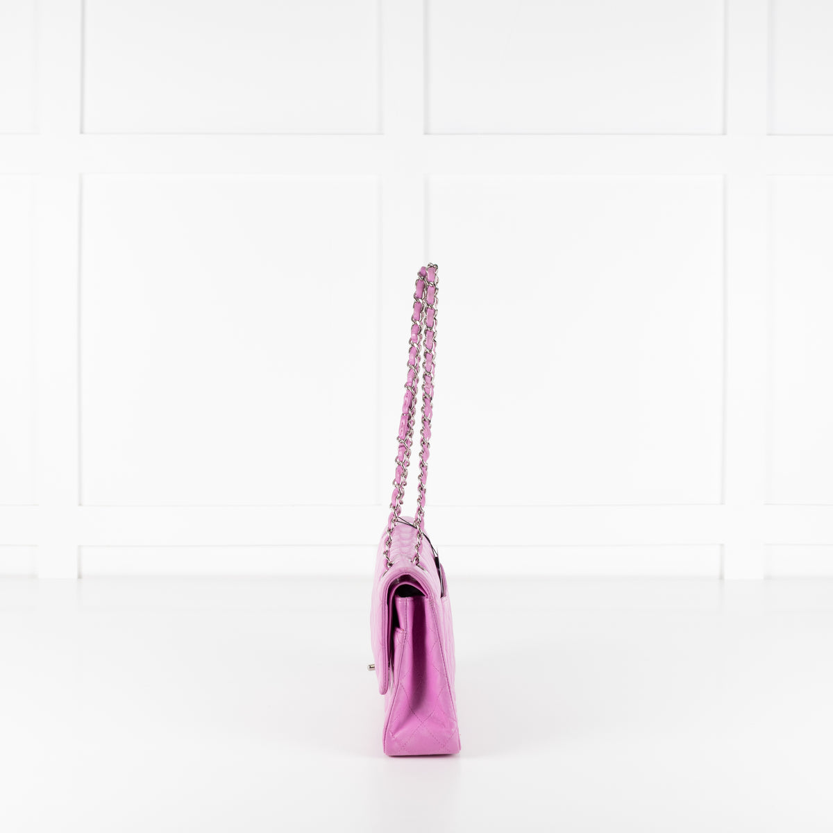 Side profile of Chanel Pink Matelasse 25 Lambskin Double Flap Bag on white background.