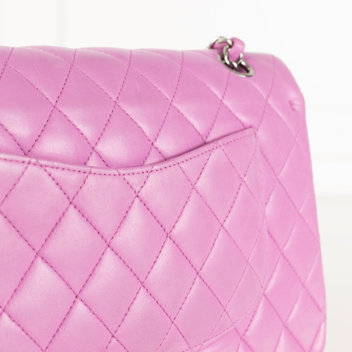 Close up of back pocket Chanel Pink Matelasse 25 Lambskin Double Flap Bag.