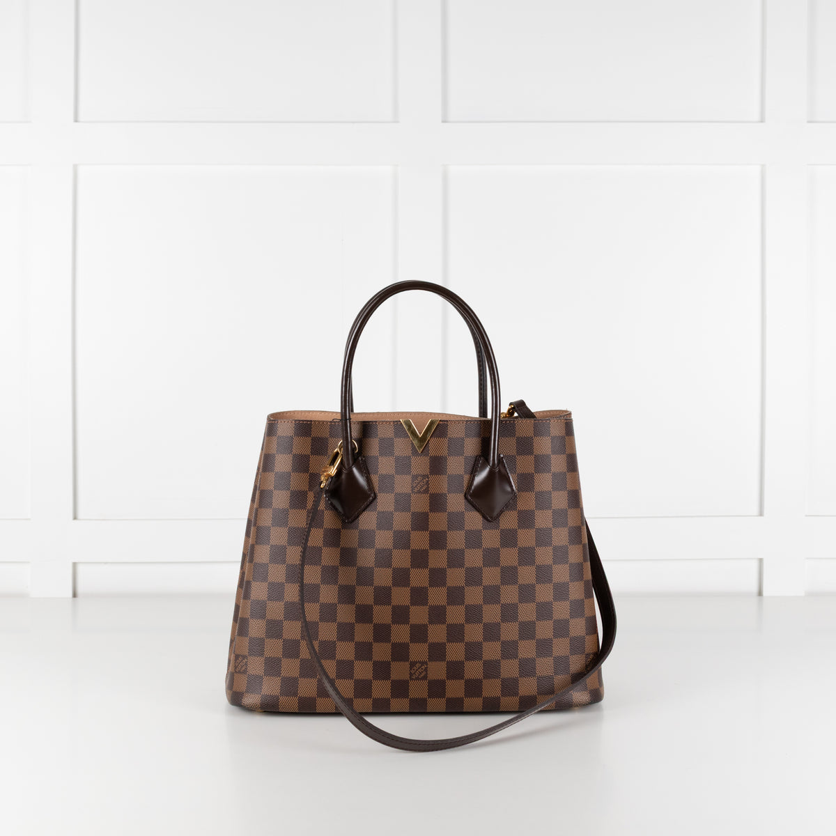 Louis Vuitton Damier Kensington Tote bag with white background.