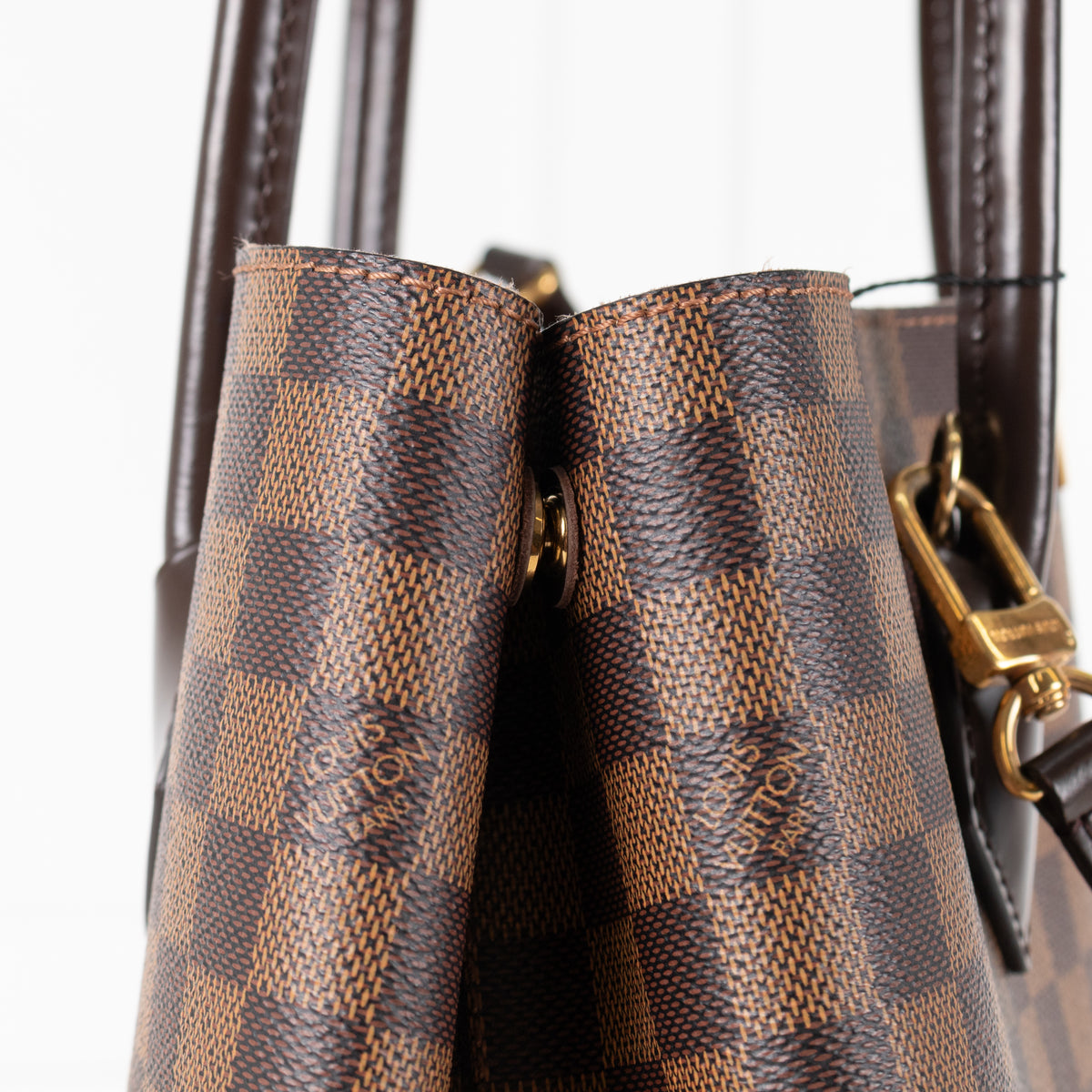 Close up of fold Louis Vuitton Damier Kensington Tote bag. 