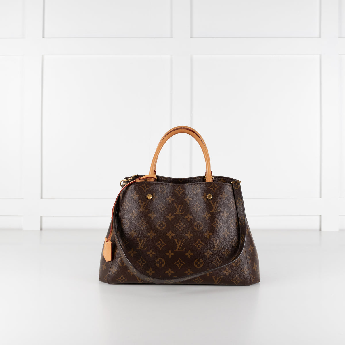 Louis Vuitton Monogram Canvas Montaigne MM bag on white background.