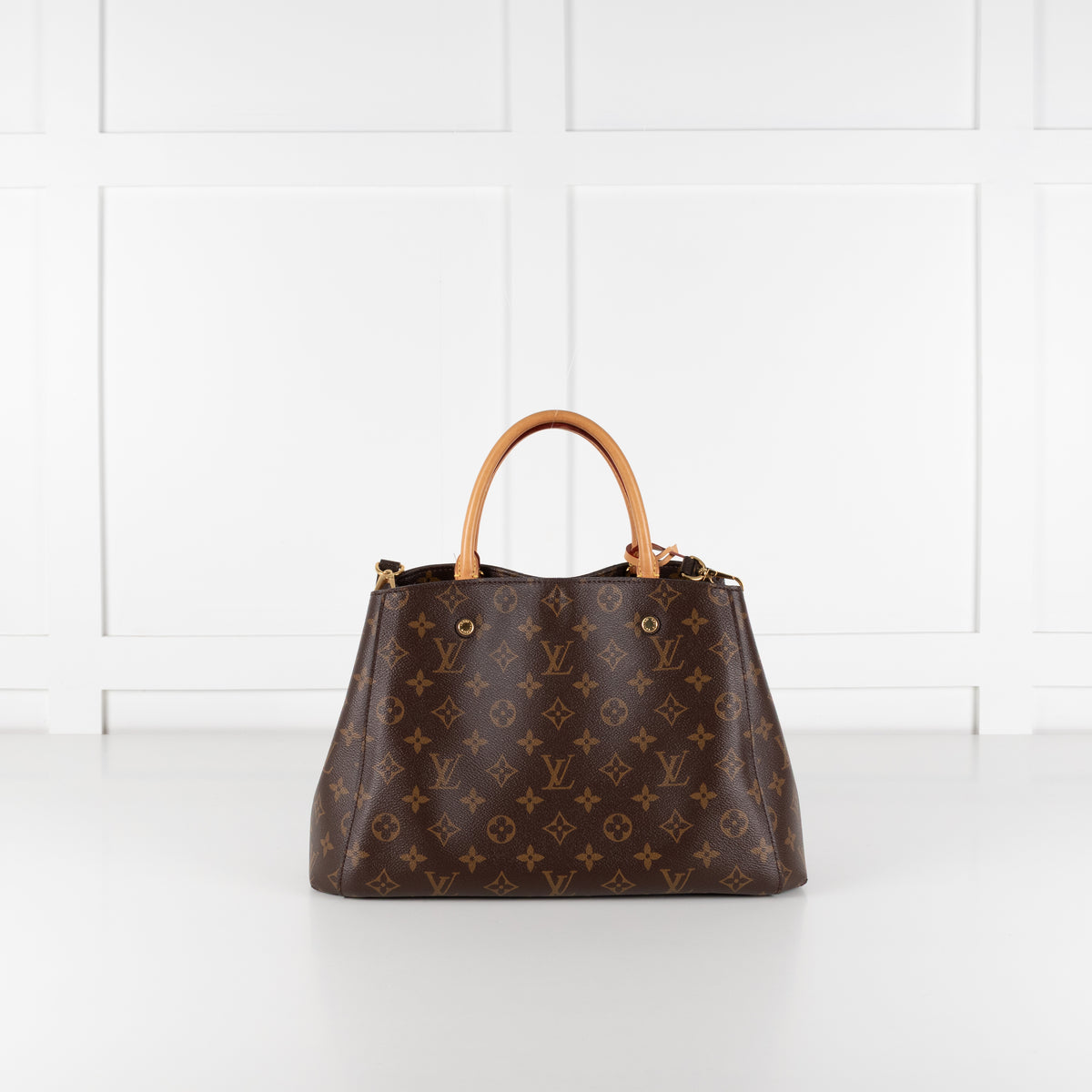 Back image of Louis Vuitton Monogram Canvas Montaigne MM bag with white background.