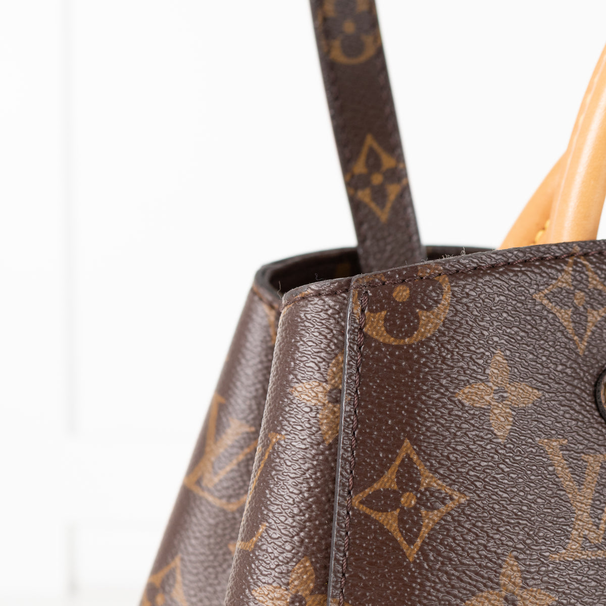Close up of Louis Vuitton Monogram Canvas Montaigne MM bag.