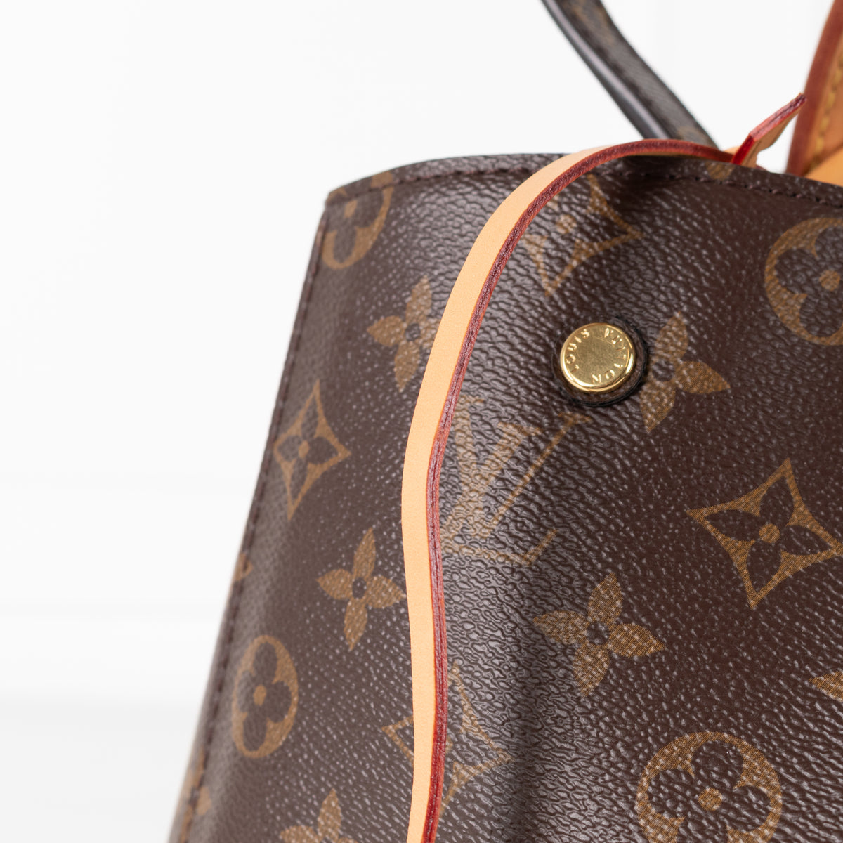 Close up of leather strap on Louis Vuitton Monogram Canvas Montaigne MM bag.
