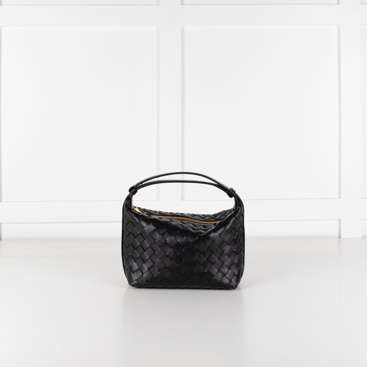 Bottega Veneta mini Wallace bag in black intrecciato leather on white background.