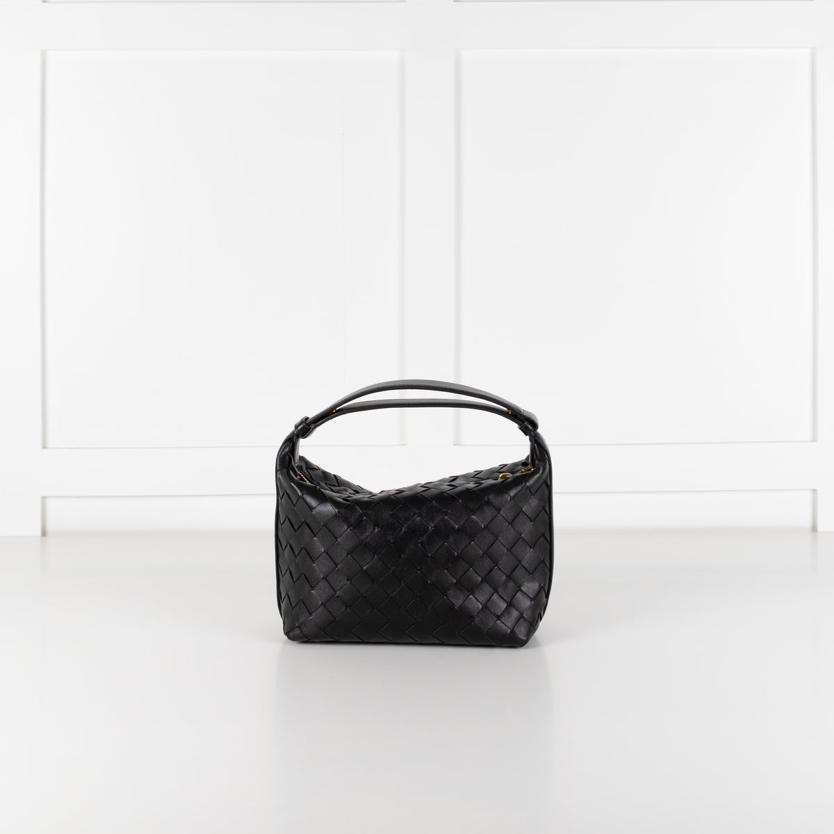 Bottega Veneta mini Wallace bag in black intrecciato leather on white background. 