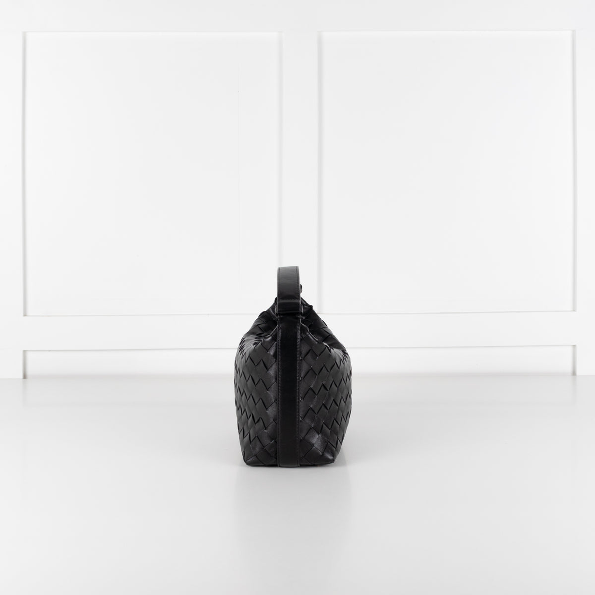 Black Bottega Veneta mini Wallace bag in intrecciato leather on white background in Phoenix Style studio.