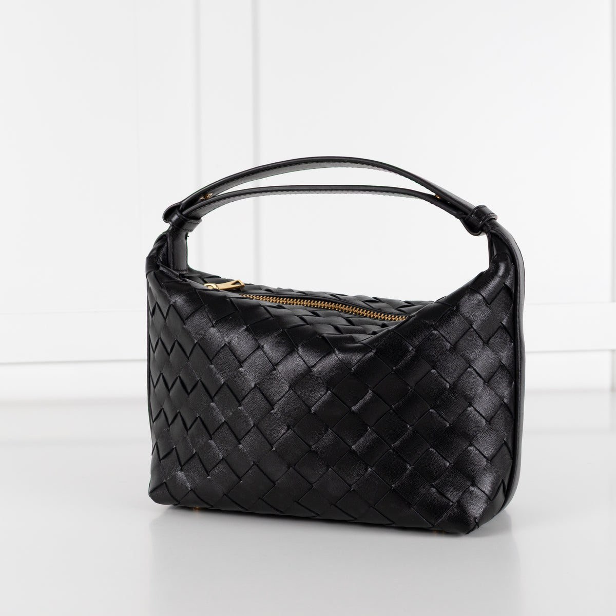 Close up of Black Bottega Veneta mini Wallace bag in intrecciato leather on white background in Phoenix Style shop.