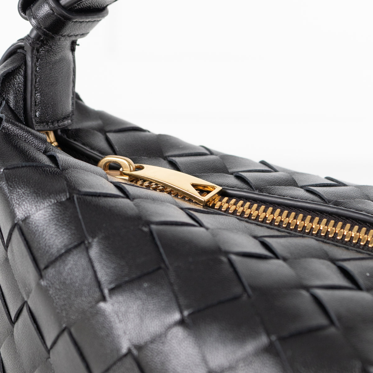 Close up of Black Bottega Veneta mini Wallace bag in intrecciato leather gold hardware.