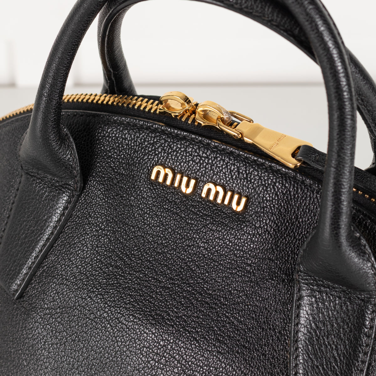 Miu Miu black grained Madras leather dome bag