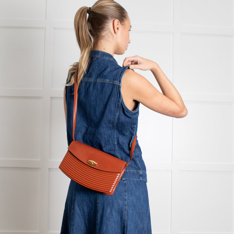Woman wearing a blue denim dress with a Louis Vuitton Vintage Epi Prebourg Leather Kenya Brown 36 crossbody. 