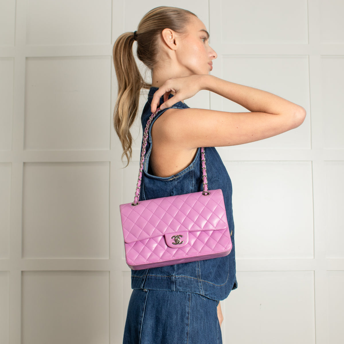 model holding preloved Chanel Pink Matelasse 25 Lambskin Double Flap Bag.