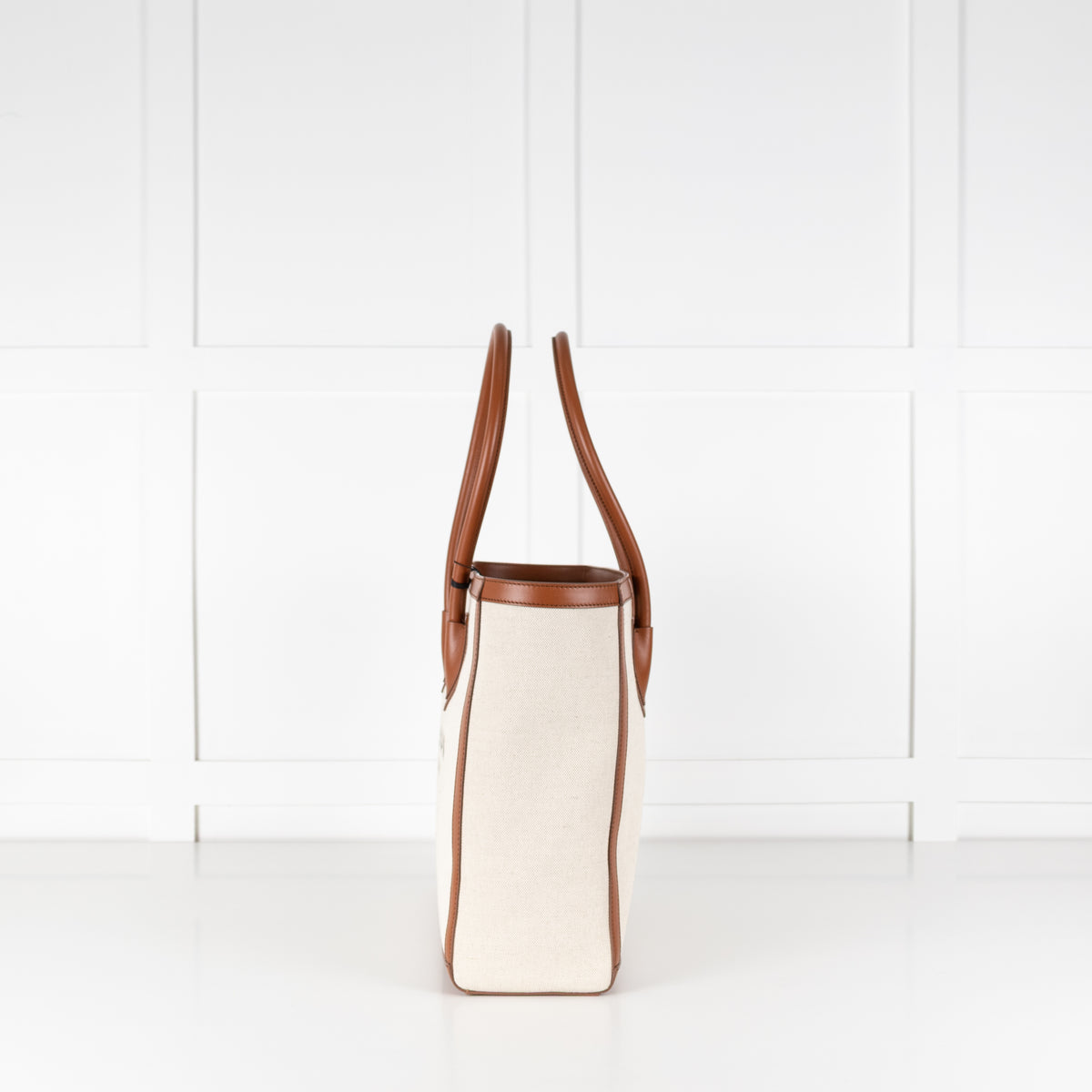 Pre-loved Balmain canvas and leather tote bag side profile in Phoenix style. 