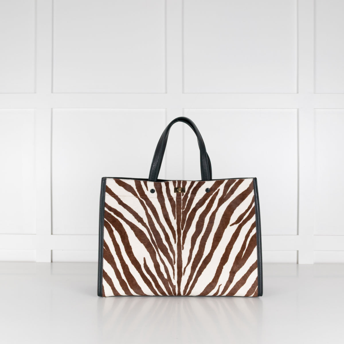 Anya Hindmarch Large Tote bag with zebra pattern on a white surface with a light wood panel background