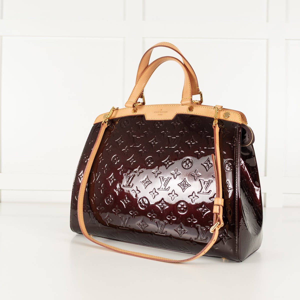 Brown Louis Vuitton handbag on a white background