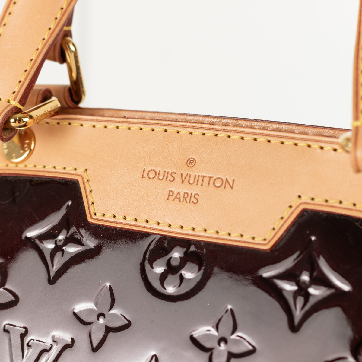 Louis Vuitton handbag with brand logo and embossed pattern