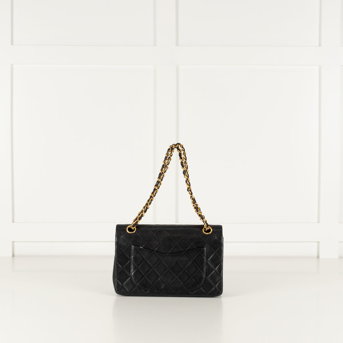 Back of the vintage Chanel black hangbag in phoenix style studio.