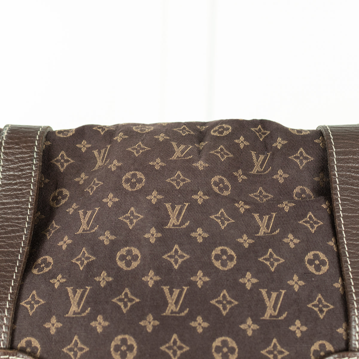 Brown fabric with Louis Vuitton monogram pattern on a white background