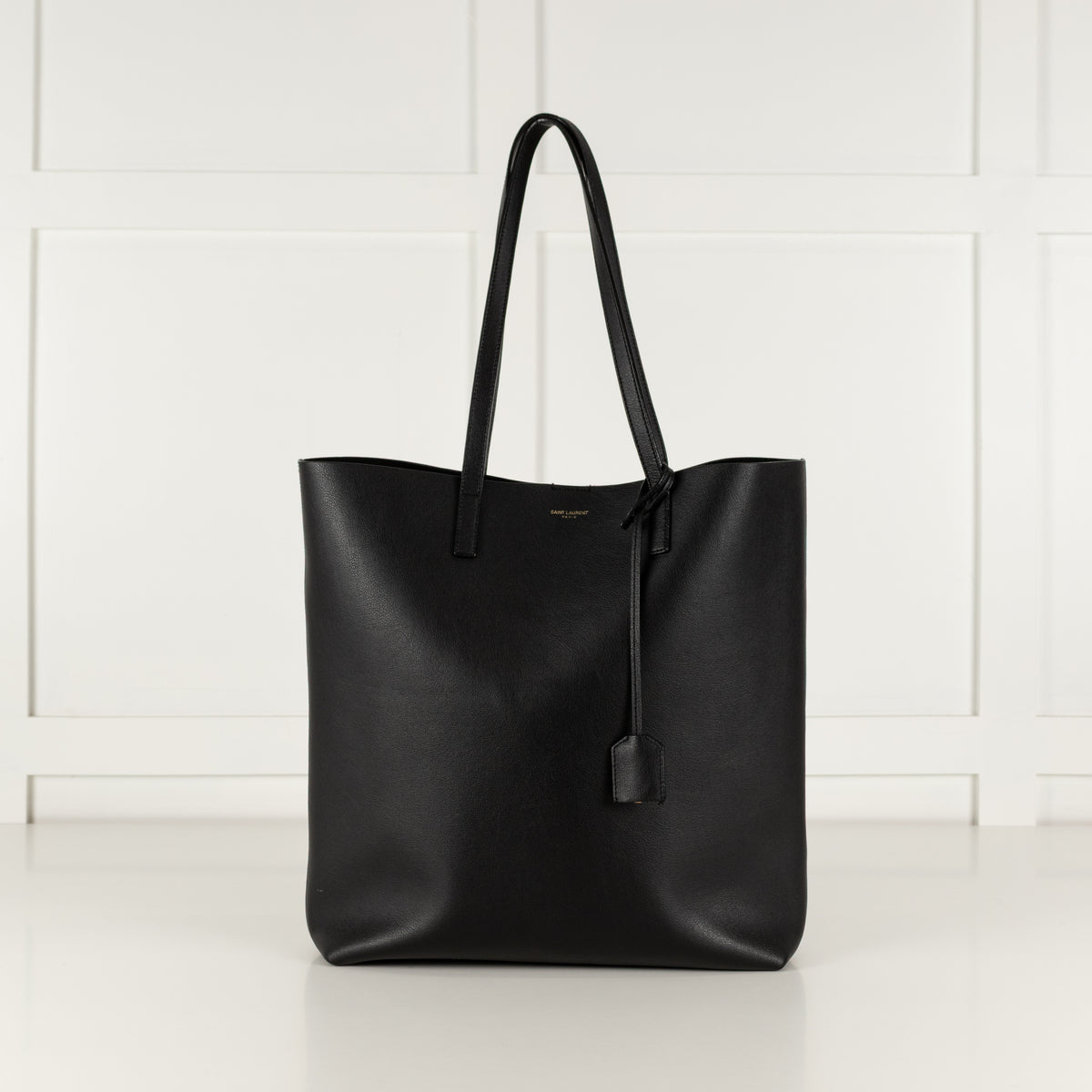 Saint Laurent Black leather tote bag on a white background.