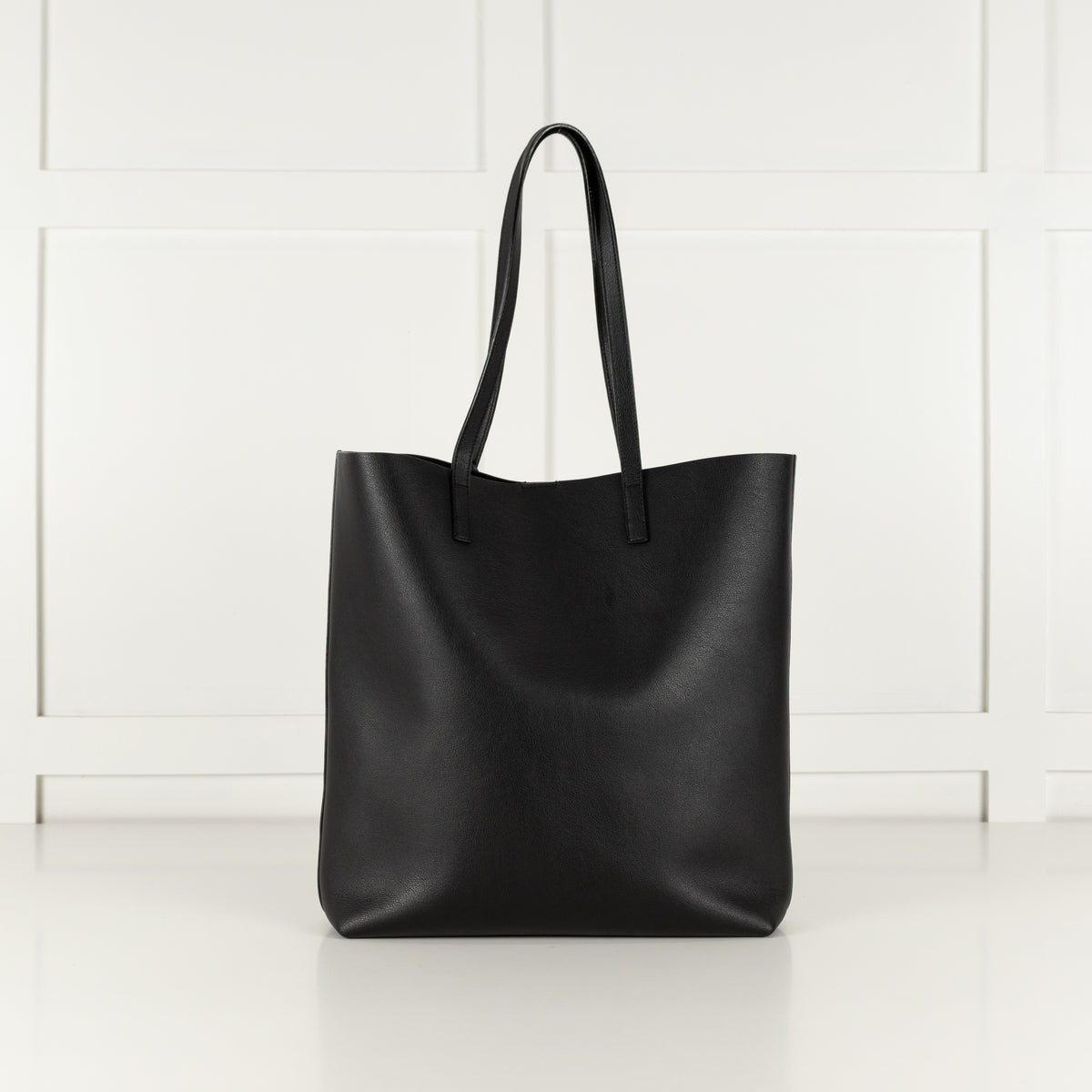 Back of a black saint laurent leather tote handbag.