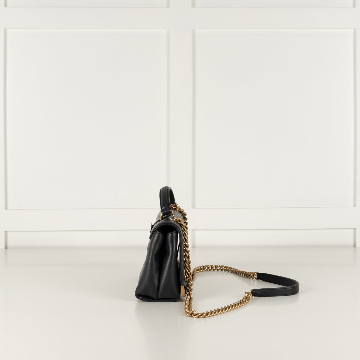 Side image of Navy Preloved Chanel Handbag on white background.