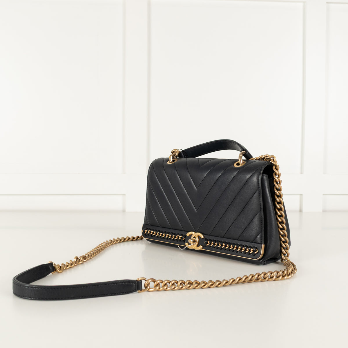 Side angle Navy Preloved Chanel Handbag on white background.