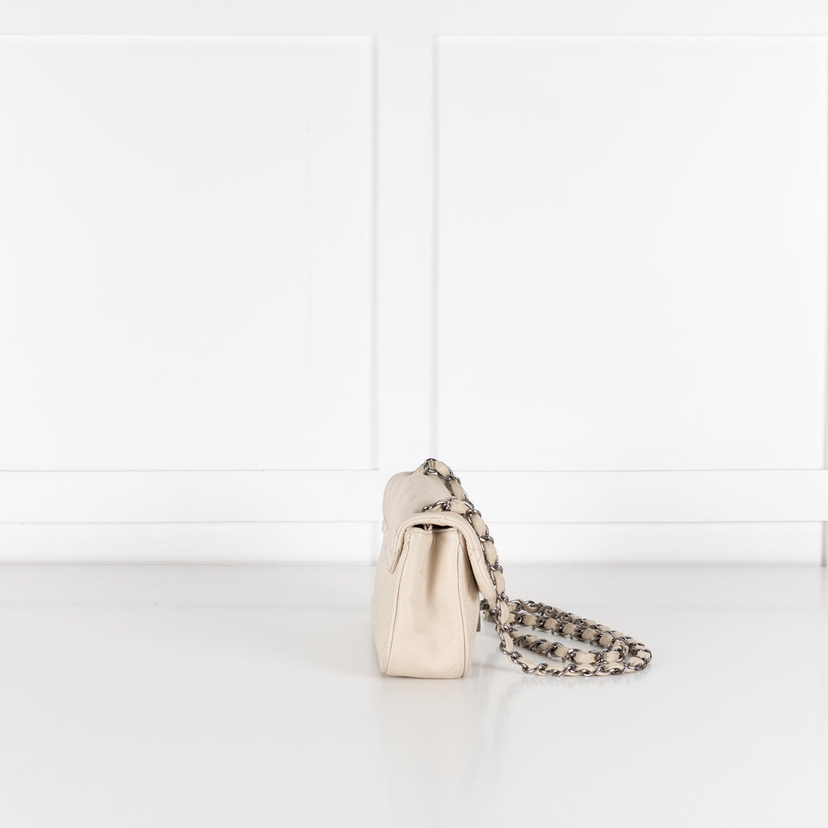 Chanel vintage Mademoiselle flap bag side profile with silver hardware.