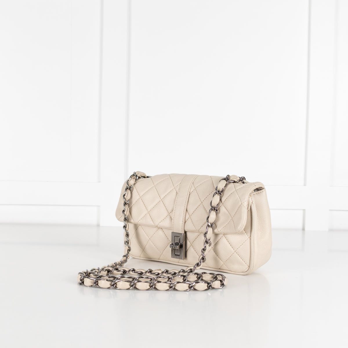 Preloved Chanel vintage Mademoiselle flap handbag with white background in phoenix style shop.