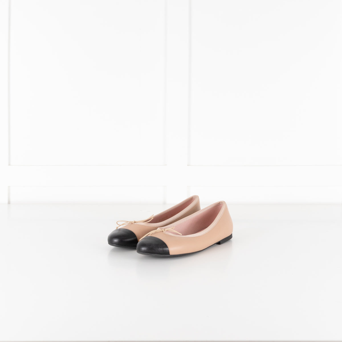 Pretty Ballerinas Nude Ballet Flats With Black Cap-Toe And Bow Detail