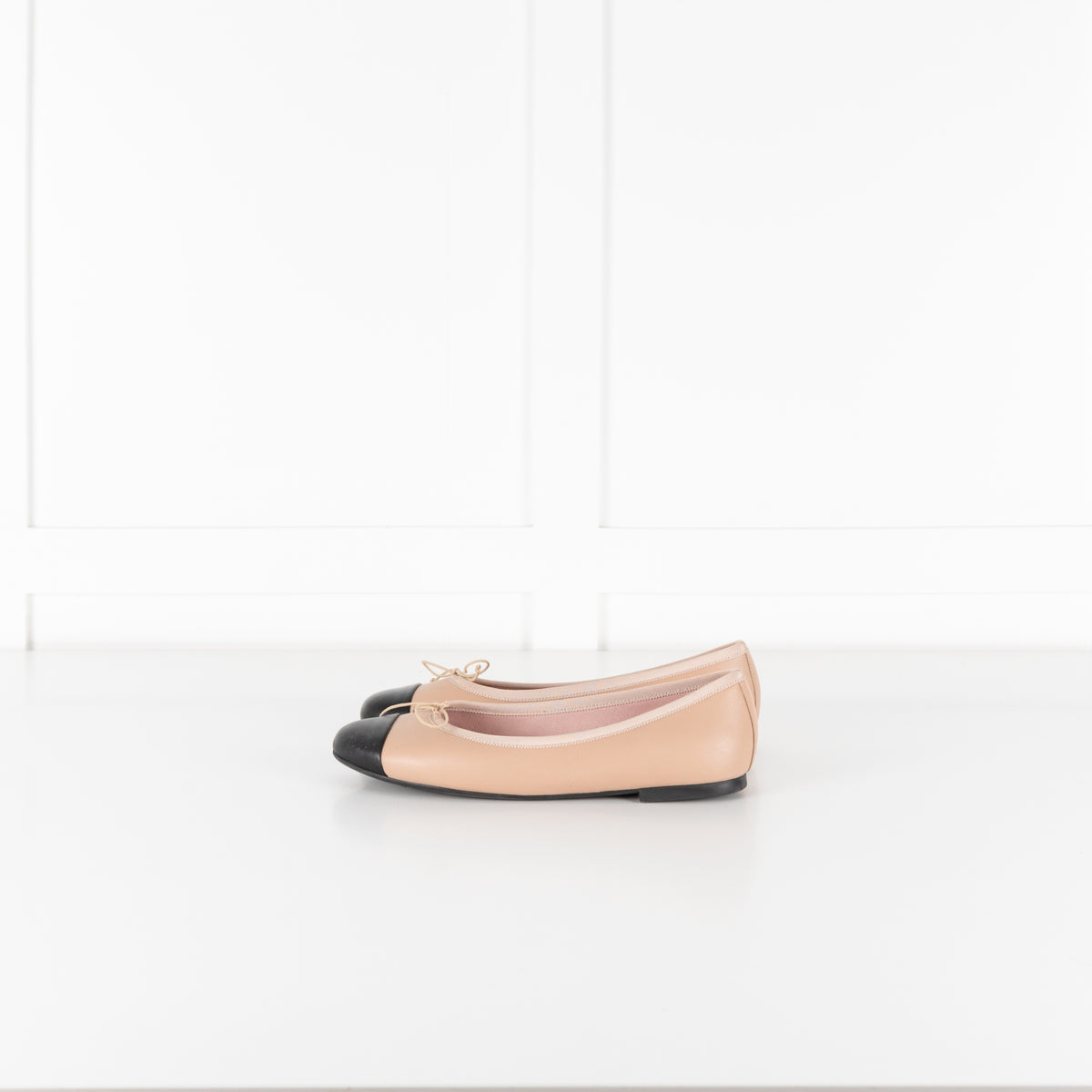 Pretty Ballerinas Nude Ballet Flats With Black Cap-Toe And Bow Detail