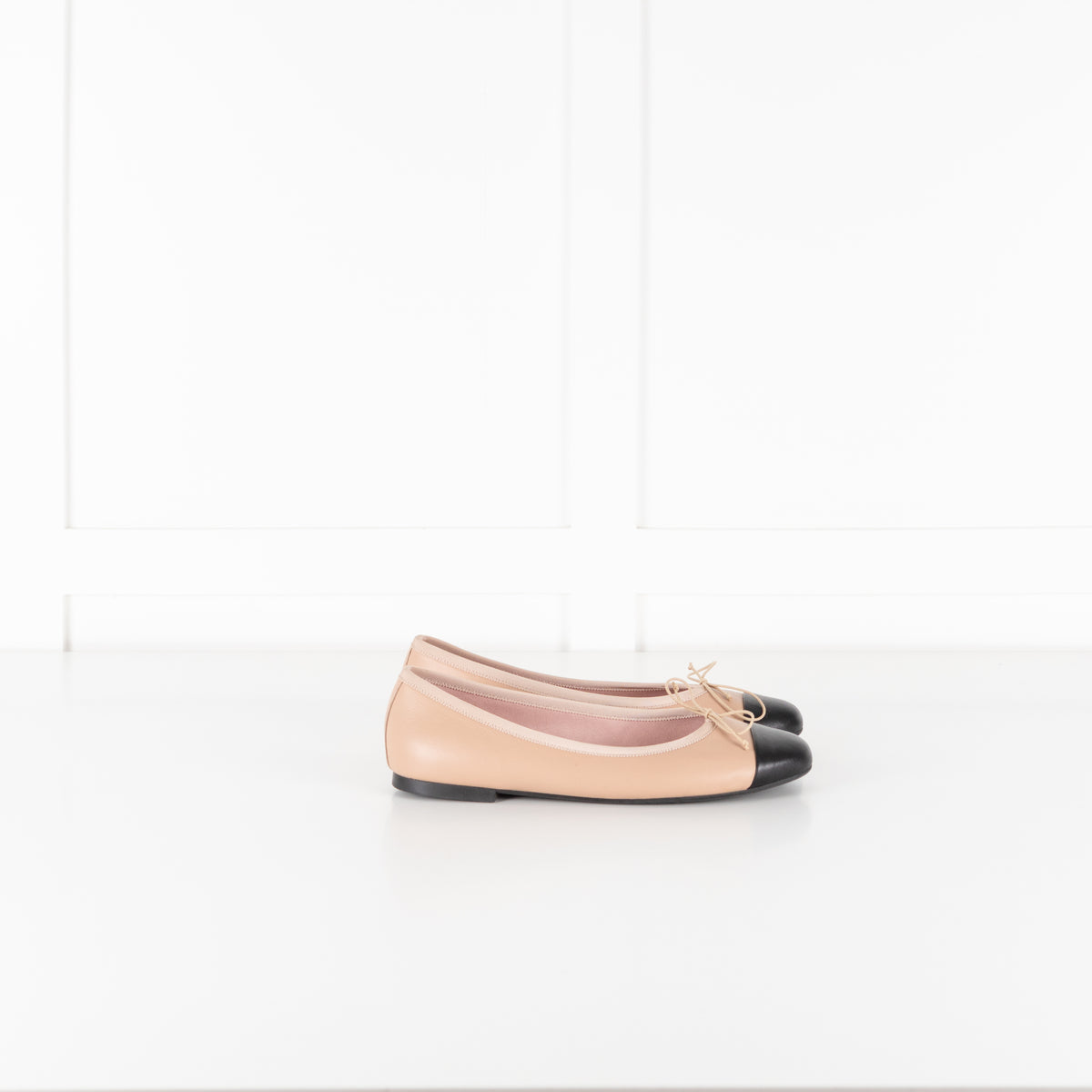Pretty Ballerinas Nude Ballet Flats With Black Cap-Toe And Bow Detail