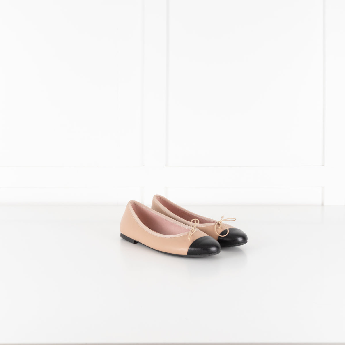 Pretty Ballerinas Nude Ballet Flats With Black Cap-Toe And Bow Detail