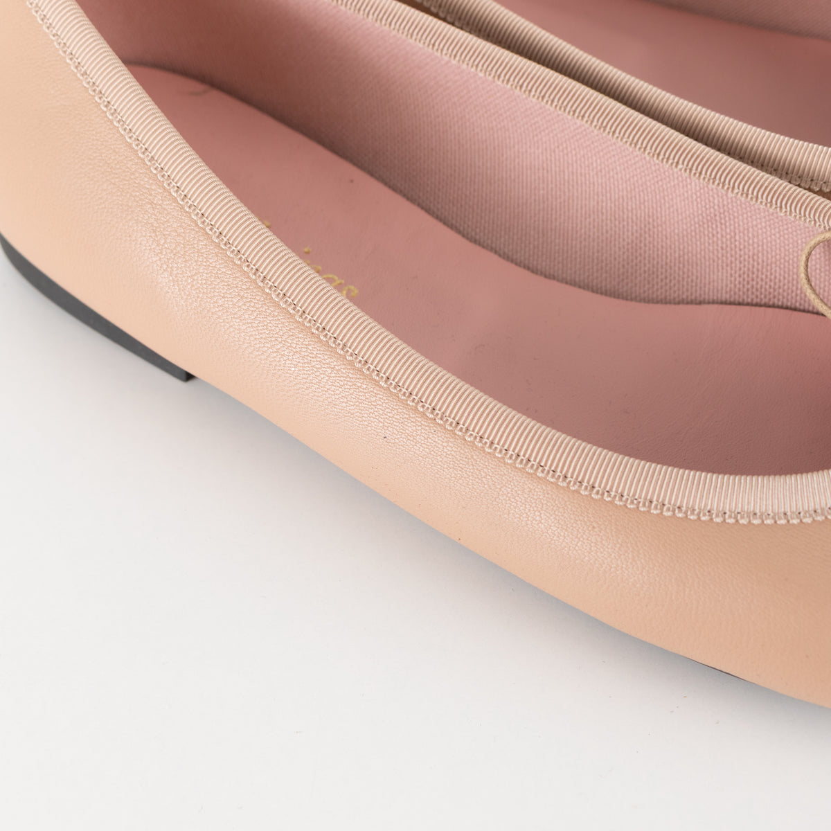 Pretty Ballerinas Nude Ballet Flats With Black Cap-Toe And Bow Detail