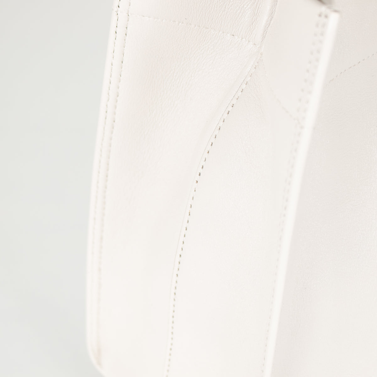 Close of up stiching on Anya Hindmarch White Calf Leather Mortimer Small Tote Bag.
