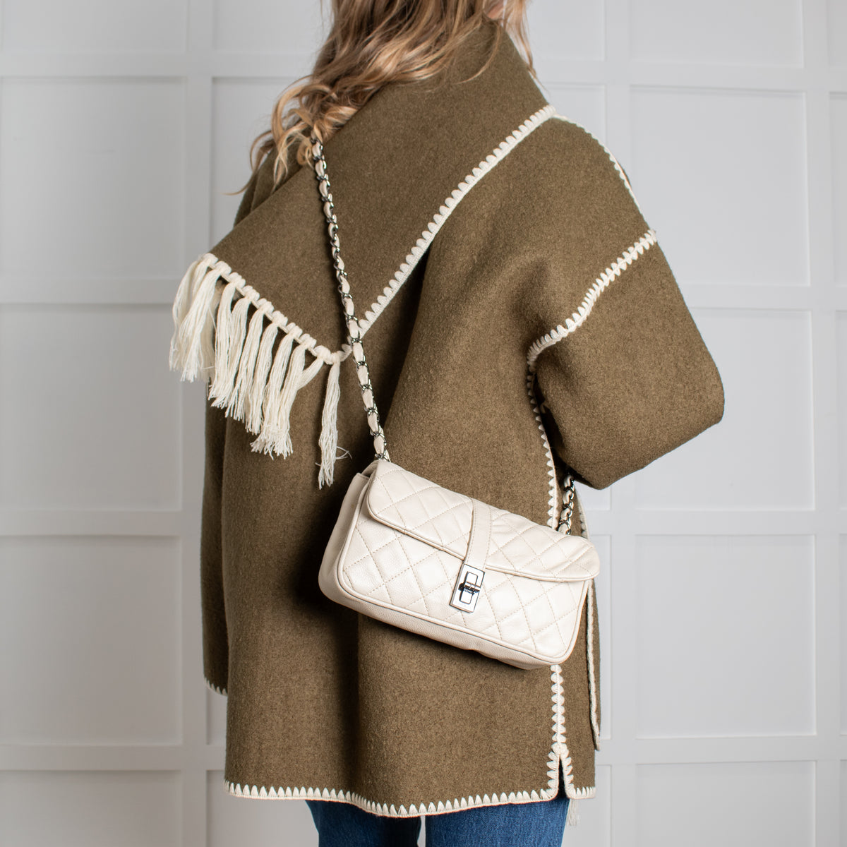 Model wearing pre loved Chanel vintage Mademoiselle flap handbag.