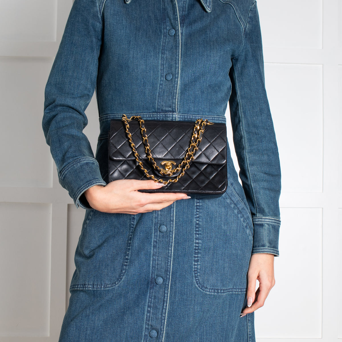 Model holding vintage black Chanel handbag in Phoenix Style shop.