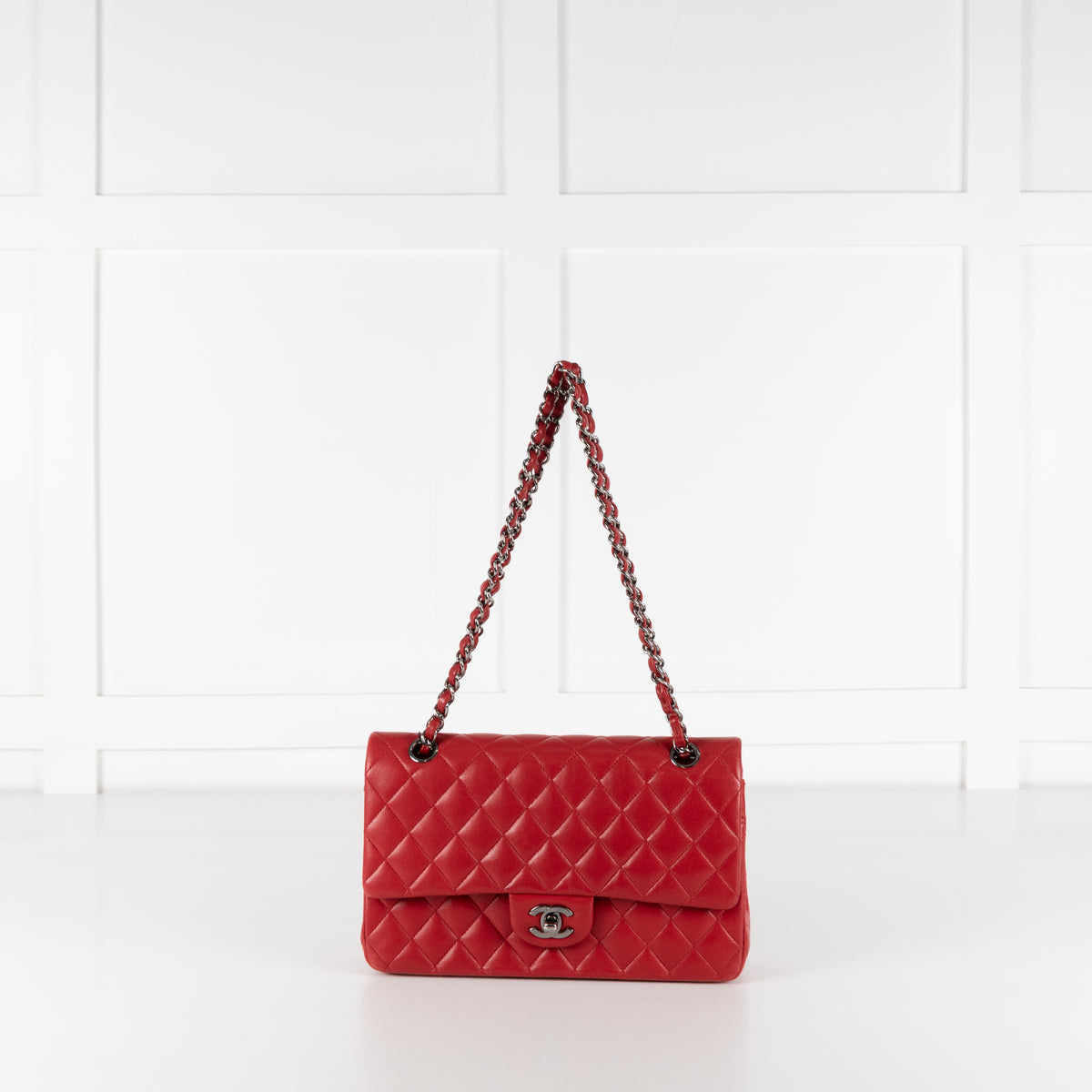 Chanel Red Matelasse Medium Lambskin Double Flap handbag with white background.