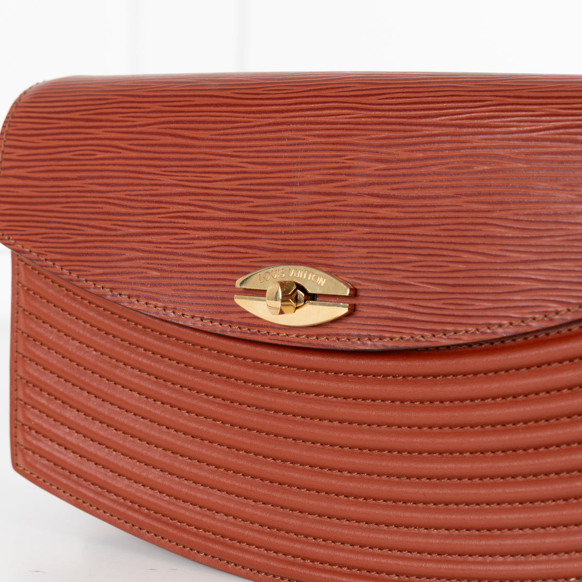 Close up of gold hardware on Louis Vuitton Vintage Epi Prebourg Leather Kenya Brown 36 handbag.